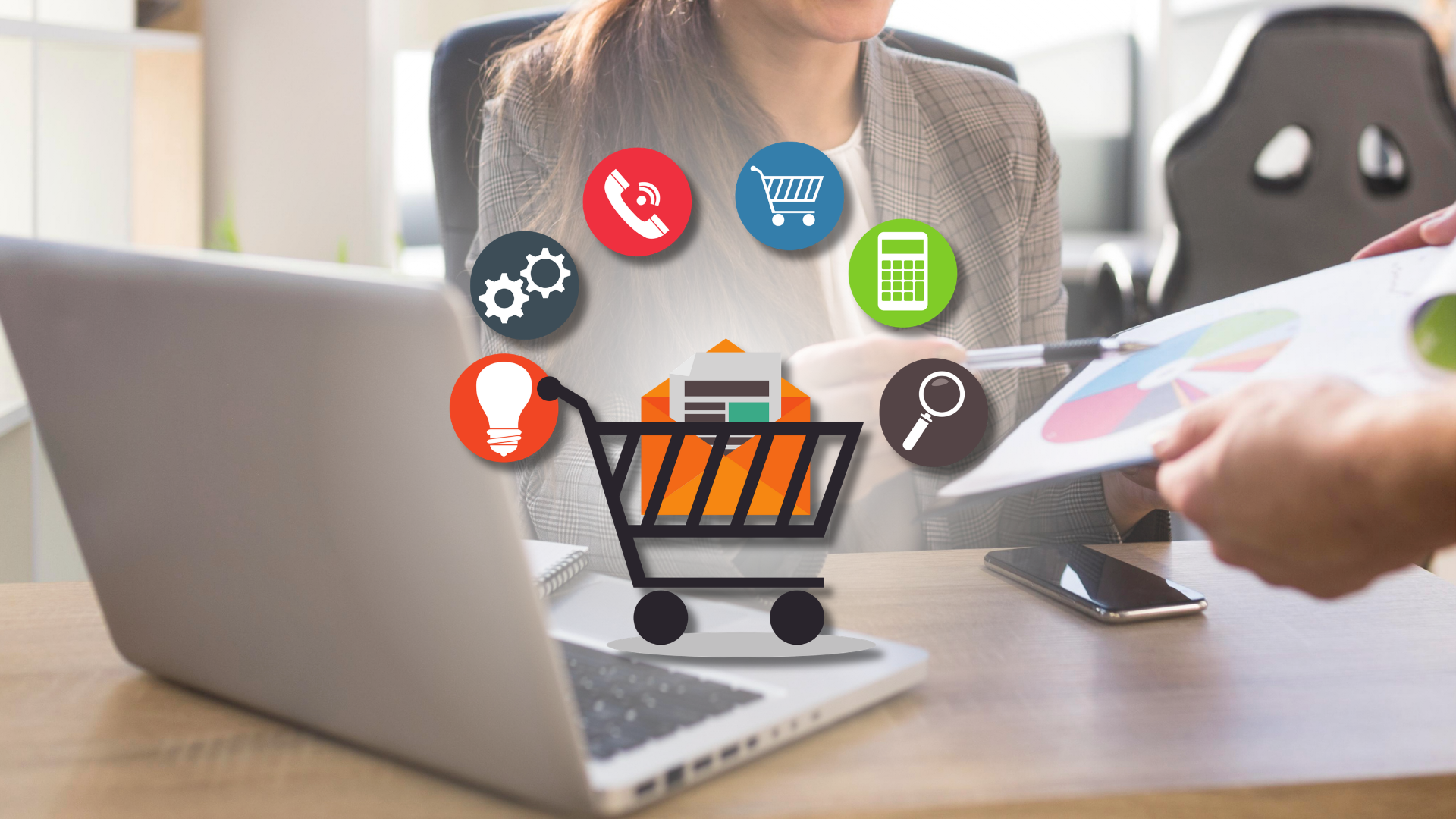 Woman at a laptop discussing a pie chart with someone, e-commerce icons above the desk – recruiting an E-commerce Manager